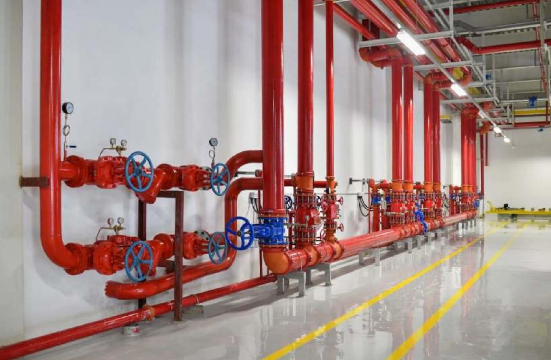 Fire fighting pump room with red hydrant and sprinkler piping